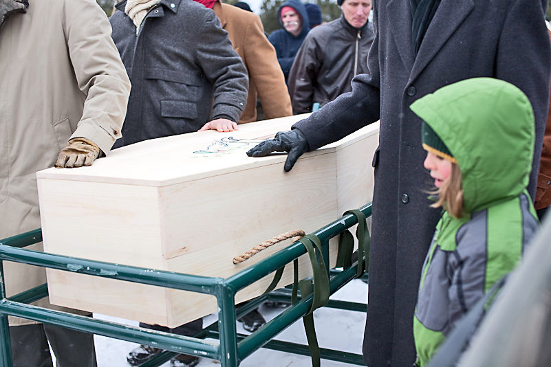 Mourners carry the casket of their beloved during a funeral at Greensprings Natural Cemetery in Newfield. (Photo: Provided)